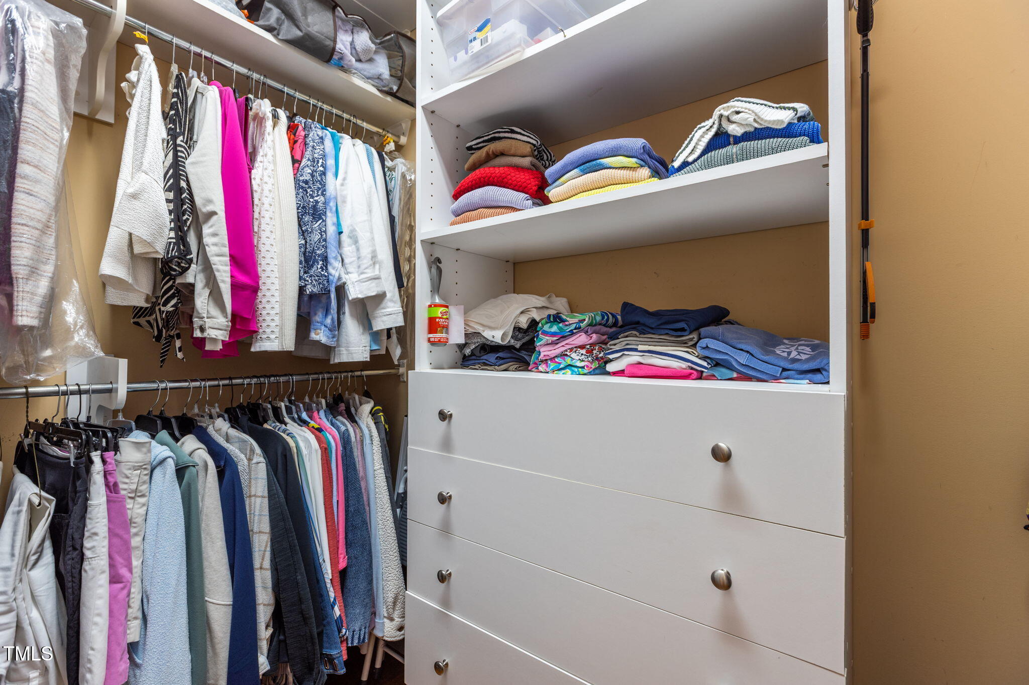 206 Nouveau Avenue Raleigh, NC 27615 - Photo 40 of 61 a view of walk in closet with clothes and shoes