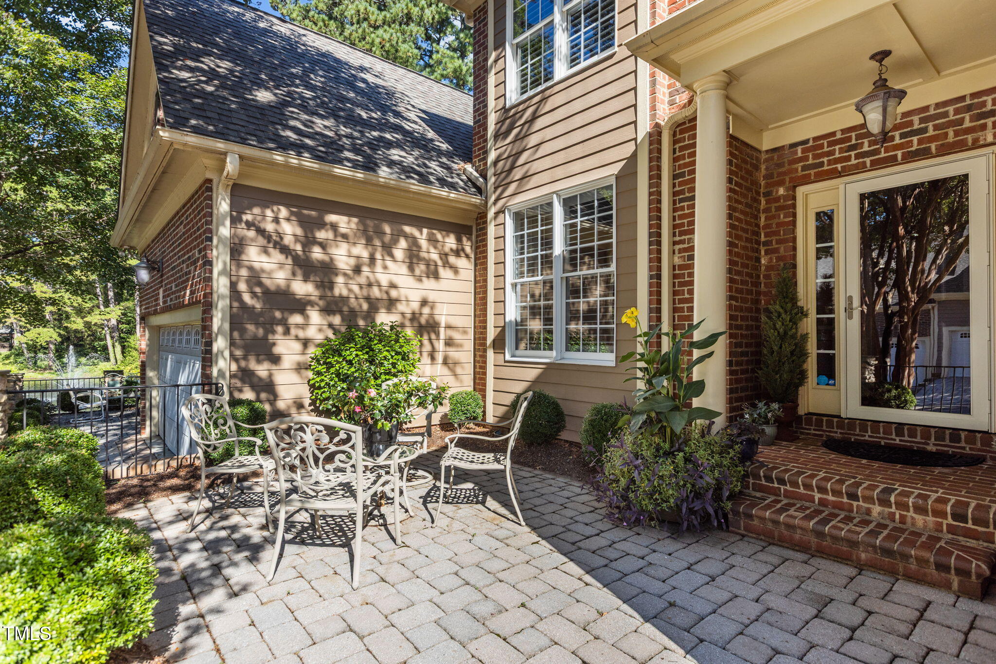 206 Nouveau Avenue Raleigh, NC 27615 - Photo 51 of 61 a view of a patio with table and chairs and potted plants
