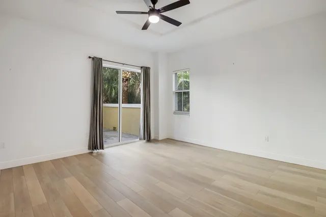 a bathroom with a granite countertop tub sink and mirror