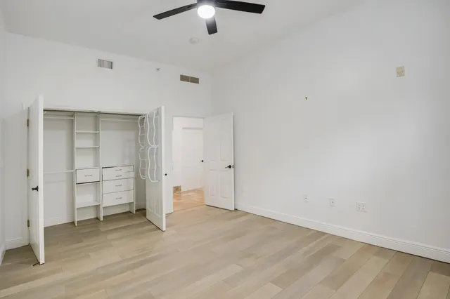 a bathroom with a granite countertop sink toilet mirror and bathtub