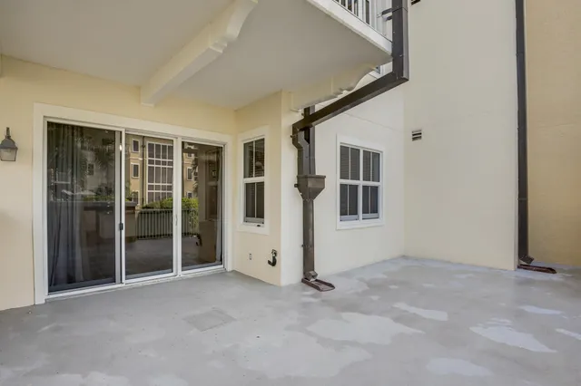 a view of a backyard with a patio and swimming pool