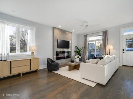 a living room with furniture a flat screen tv and a large window
