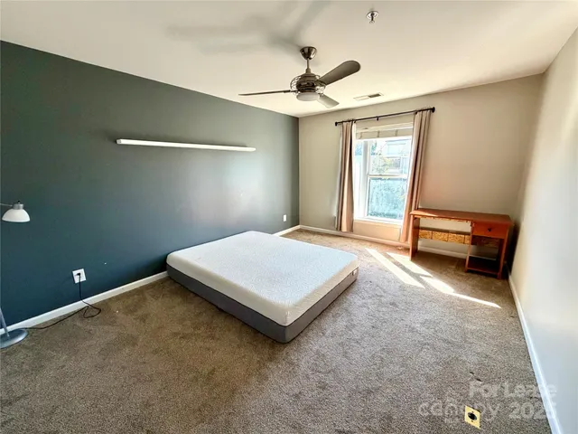 a bed room with a bed and a chandelier