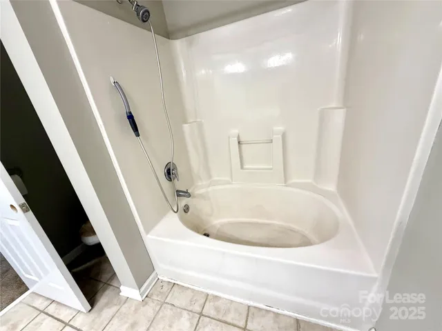 a white bath tub sitting in a bathroom