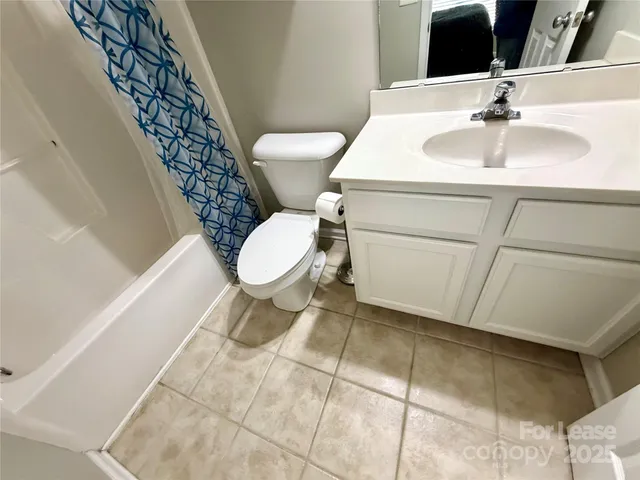 a white toilet sitting next to a bathroom sink