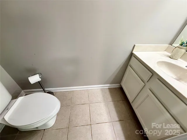 a bathroom with a sink toilet and mirror