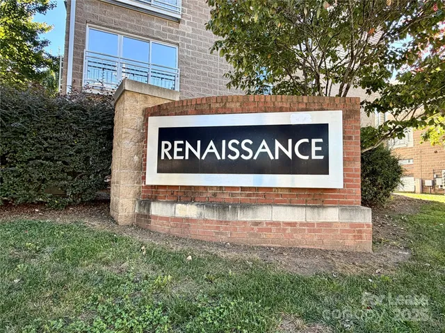 a sign broad in front of the red brick house
