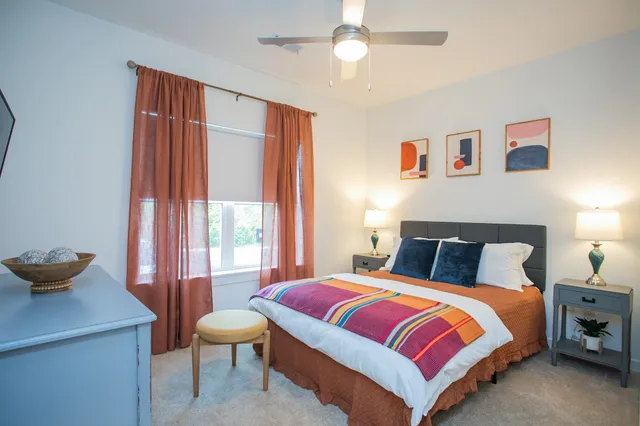 a bedroom with a bed and a window