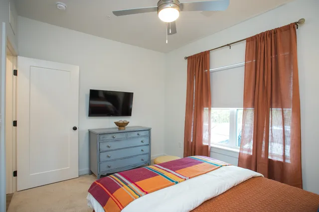 a bedroom with a bed and a television