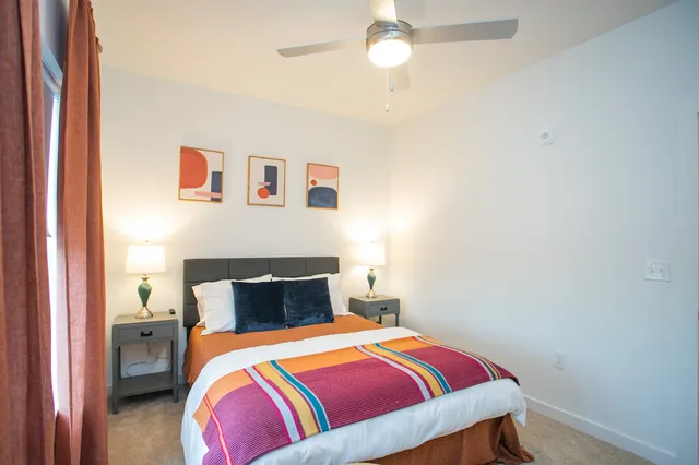 a bedroom with a bed and a painting on the wall