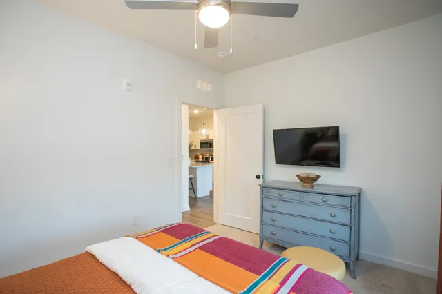 a room with a bed and a television