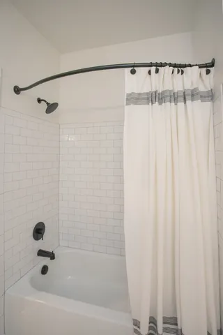 a bathroom with a shower and a bathtub