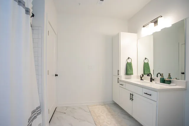 a bathroom with a double vanity sink and mirror