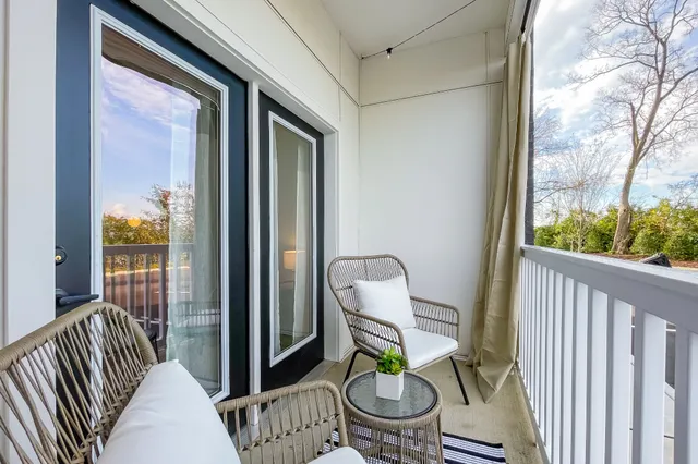 a view of a balcony with chair and wooden floor