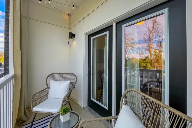 a view of a hallway with wooden floor and windows