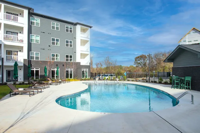 a view of a swimming pool with outdoor seating
