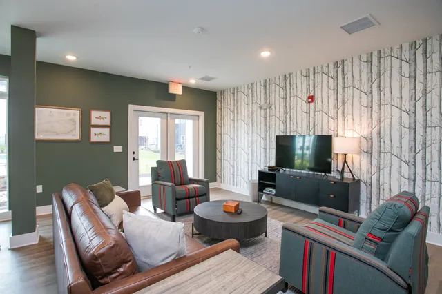 a living room with furniture and a flat screen tv