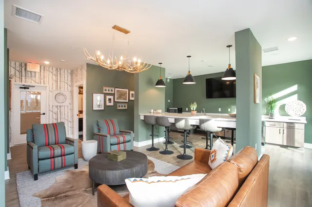 a living room with furniture and a chandelier