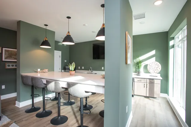 a view of a kitchen area with furniture and wooden floor