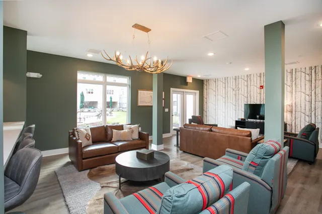 a living room with furniture and a chandelier