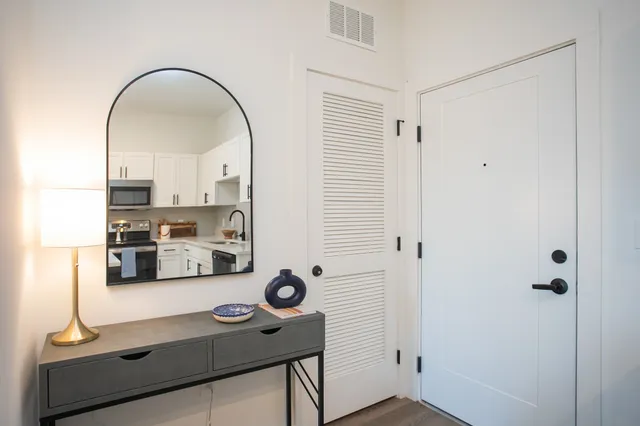 a view of a kitchen with stainless steel appliances granite countertop a refrigerator and a stove top oven