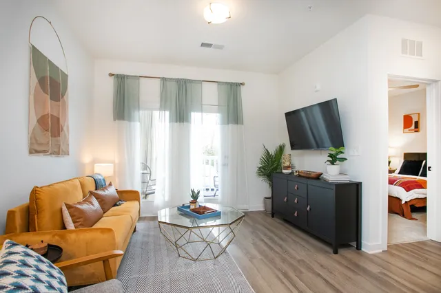 a living room with furniture and a flat screen tv