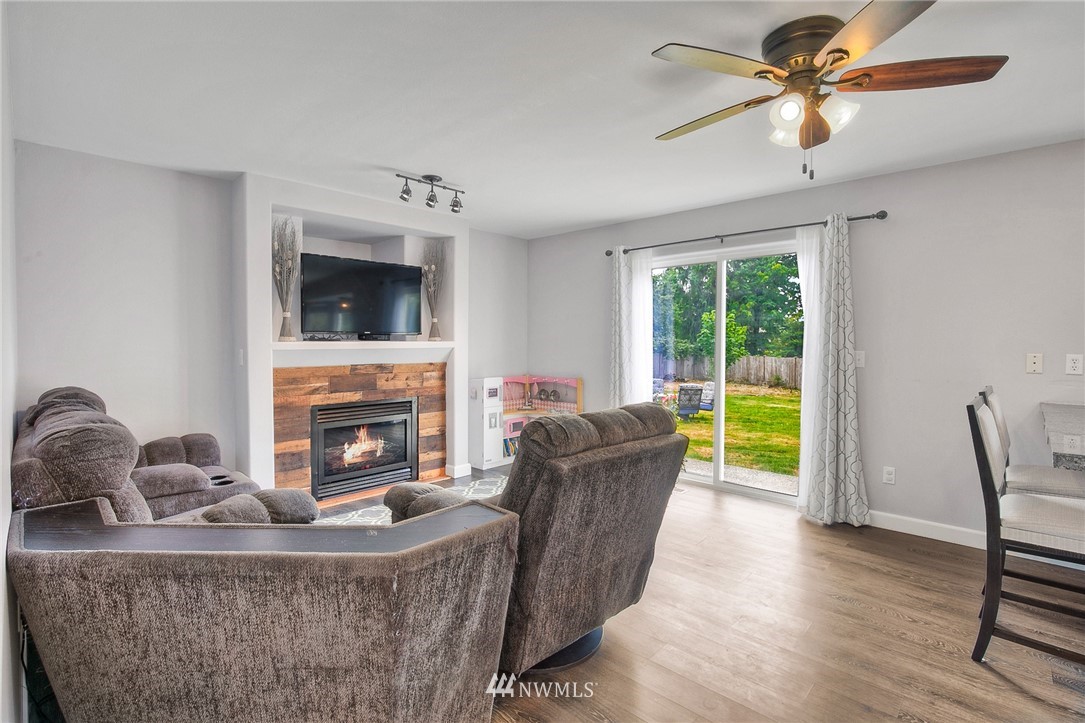 2516 Harts Lake Road South Roy, WA 98580 - Photo 12 of 32 a living room with furniture a fireplace and a flat screen tv