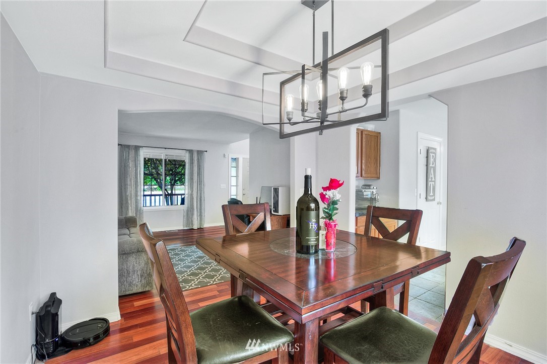 2516 Harts Lake Road South Roy, WA 98580 - Photo 13 of 32 a view of a dining room with furniture a chandelier and wooden floor
