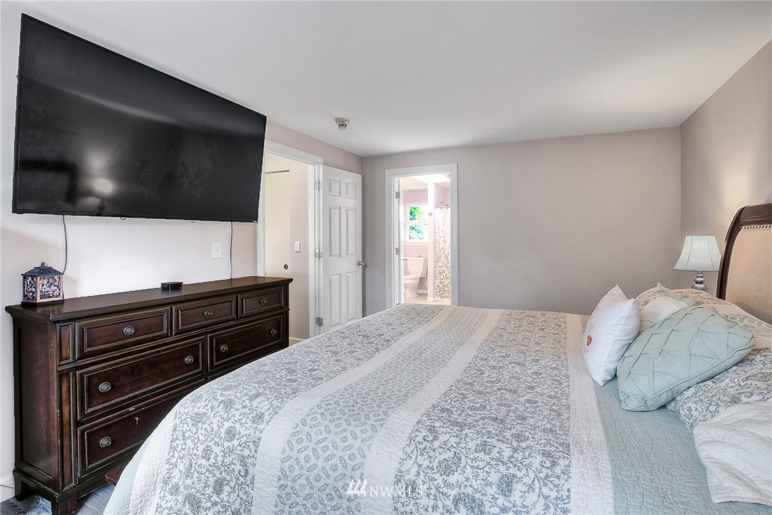 2516 Harts Lake Road South Roy, WA 98580 - Photo 18 of 32 a bedroom with a bed and a flat screen tv