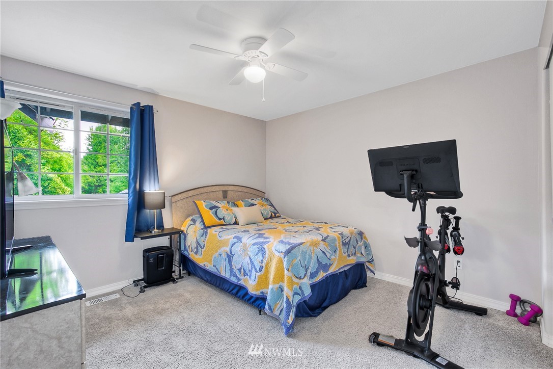 2516 Harts Lake Road South Roy, WA 98580 - Photo 20 of 32 a bedroom with a bed a chandelier and a window