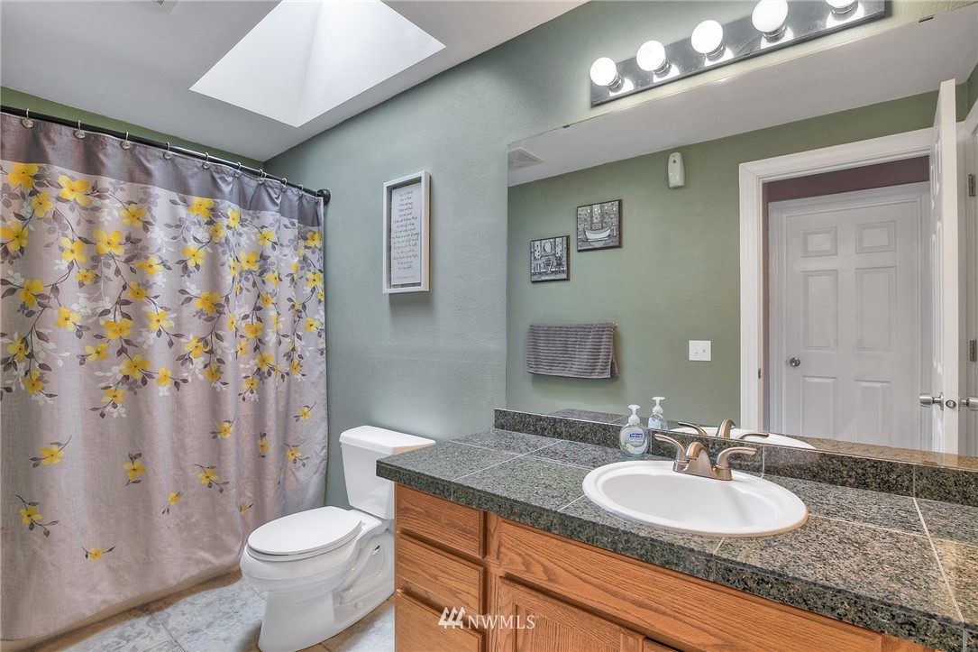 2516 Harts Lake Road South Roy, WA 98580 - Photo 21 of 32 a bathroom with a granite countertop sink and a mirror