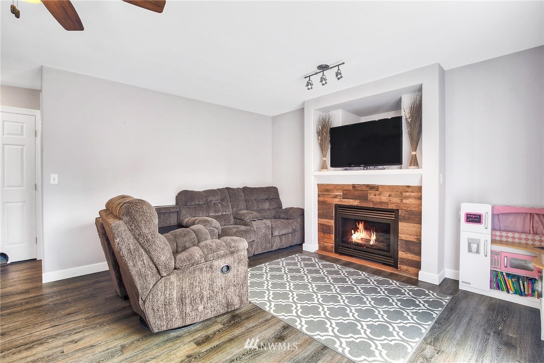 2516 Harts Lake Road South Roy, WA 98580 - Photo 8 of 32 a living room with furniture a flat screen tv and a fireplace