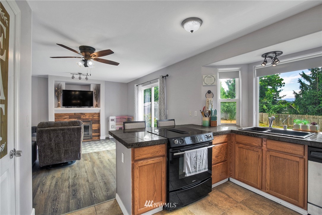 2516 Harts Lake Road South Roy, WA 98580 - Photo 10 of 32 a kitchen with a stove sink and microwave
