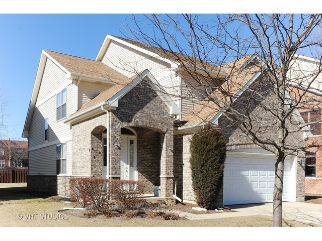 410 Raymond Road Buffalo Grove, IL 60089 - Photo 1 of 18 a view of a brick house with large windows