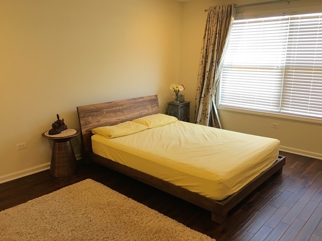 410 Raymond Road Buffalo Grove, IL 60089 - Photo 12 of 18 a bed sitting in a bedroom next to a window