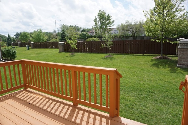 410 Raymond Road Buffalo Grove, IL 60089 - Photo 18 of 18 a view of deck with wooden floor and fence next to a yard