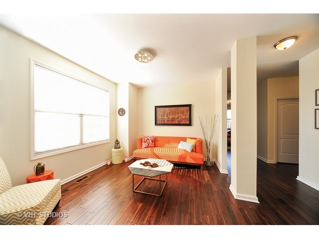 410 Raymond Road Buffalo Grove, IL 60089 - Photo 2 of 18 a bedroom with a bed and a wooden floor