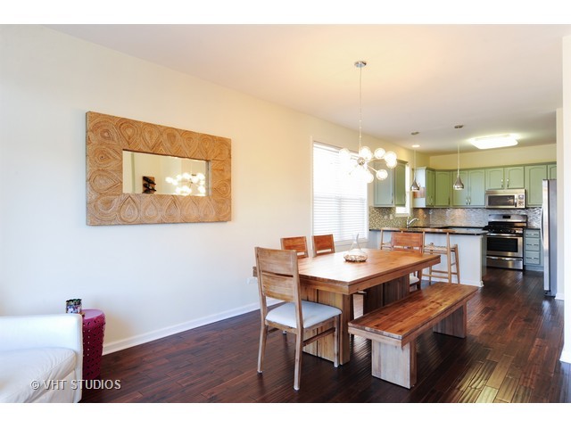 410 Raymond Road Buffalo Grove, IL 60089 - Photo 4 of 18 a view of a dining room with furniture and wooden floor