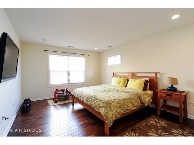 410 Raymond Road Buffalo Grove, IL 60089 - Photo 6 of 18 a bedroom with a bed and a flat tv screen on the dresser