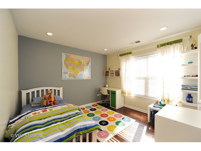 410 Raymond Road Buffalo Grove, IL 60089 - Photo 9 of 18 a bedroom with a bed and a window