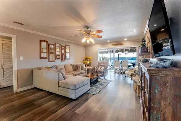 a living room with furniture and a chandelier