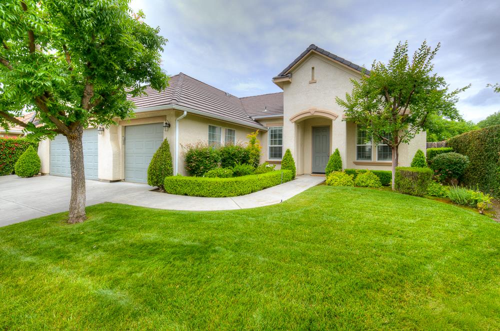 3235 Rall Avenue Clovis, CA 93619 - Photo 1 of 33 a front view of a house with a yard and potted plants