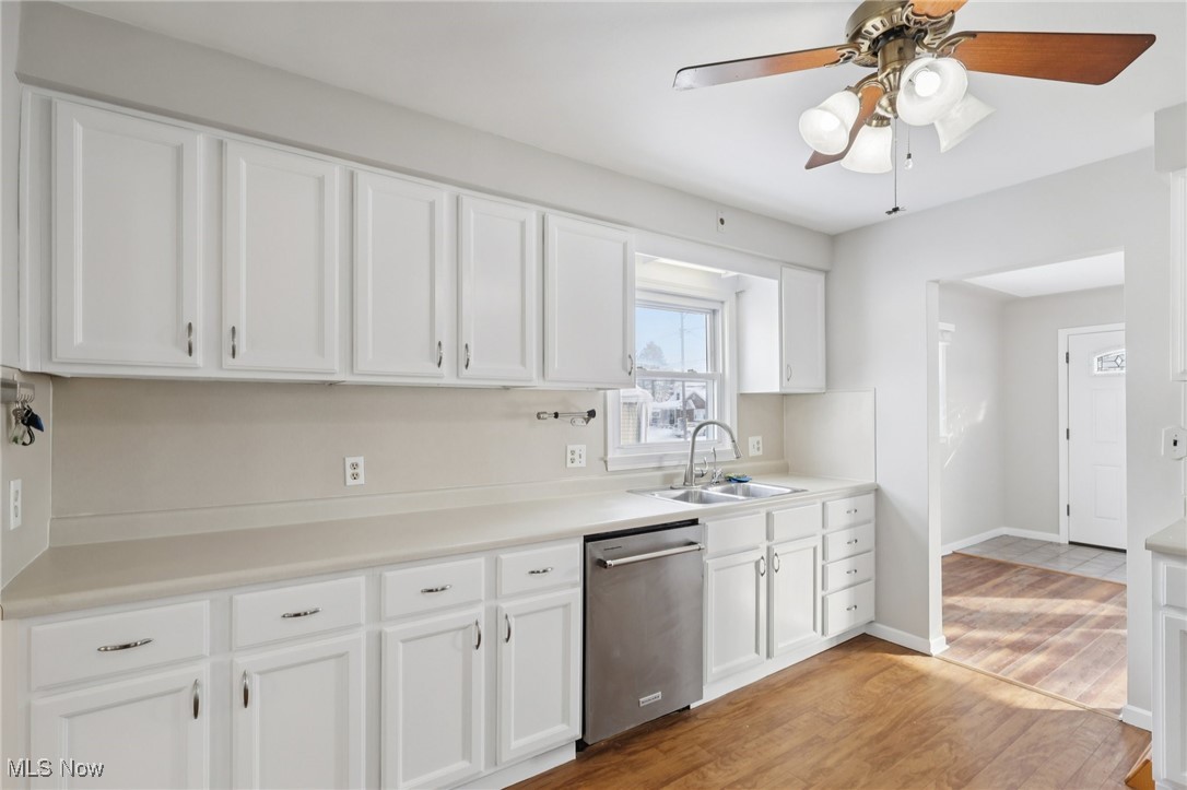 611 Wilson Street Struthers, OH 44471 - Photo 4 of 44 Kitchen featuring white cabinetry, light countertops, dishwasher, light wood-style floors, and a ceiling fan
