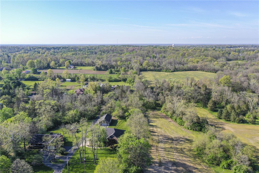 3681 Wilmington Road Lebanon, OH 45036 - Photo 73 of 87 This expansive aerial view showcases a vibrant green landscape with scattered homes and mature trees.