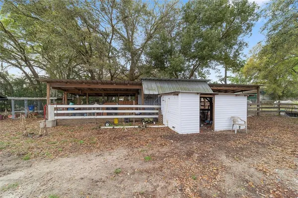a view of a house with a patio and a yard