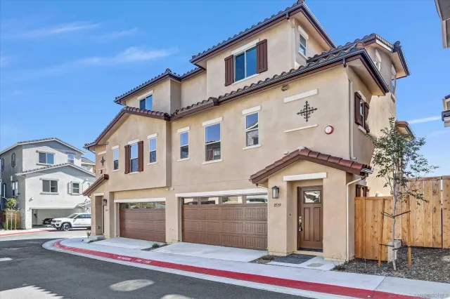 a front view of a house with a garage and balcony