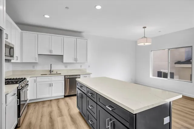 a kitchen with a stove a sink and a refrigerator