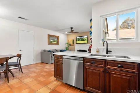 a kitchen with stainless steel appliances a sink and a stove