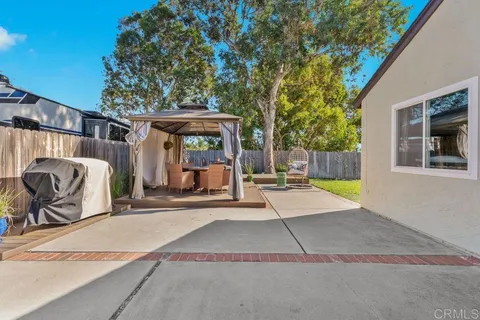 a view of a house with backyard porch and sitting area