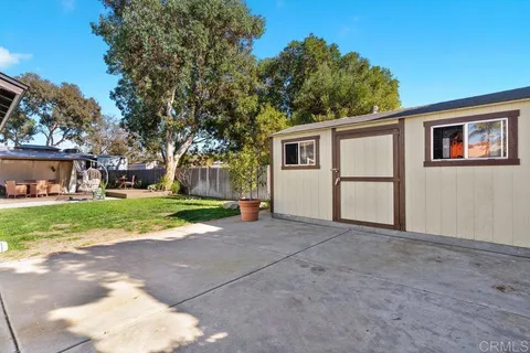 a view of a back yard with a wooden fence